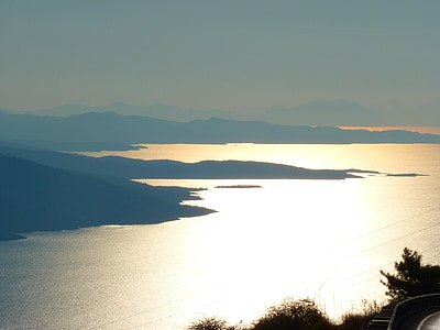 silhouette photo of mountains near body of water thumbnail
