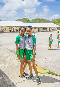 two women standing on field under blue sky thumbnail