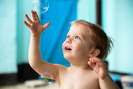 smiling boy reaching bubbles thumbnail