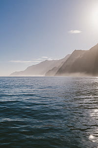 silhouette of mountain near body of water thumbnail