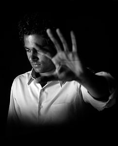 grayscale photo of man opening his left palm thumbnail