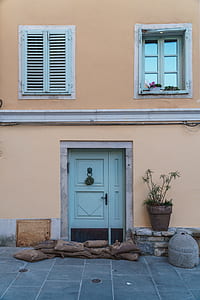 closed blue 2-panel door with sandbags in front thumbnail
