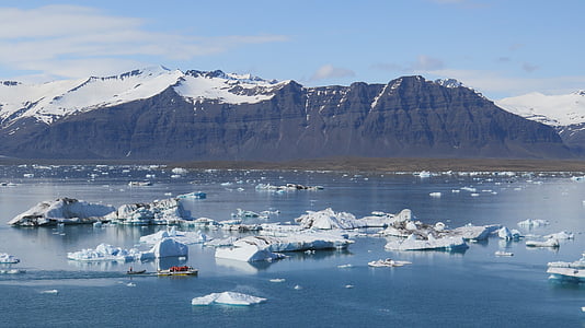 person sailing surrounded by icebergs thumbnail