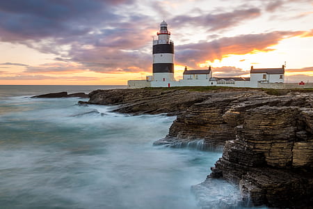 lighthouse on rocky cliff thumbnail