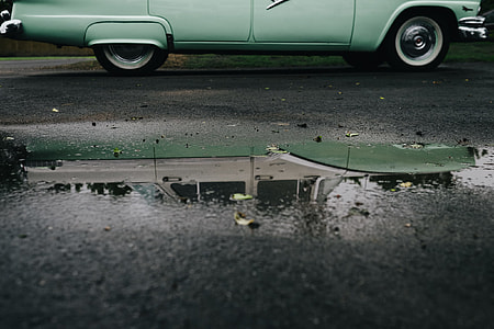 photography of green vehicle on wet road thumbnail