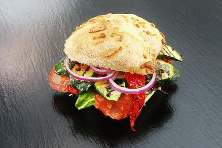 burger on black wooden surface thumbnail