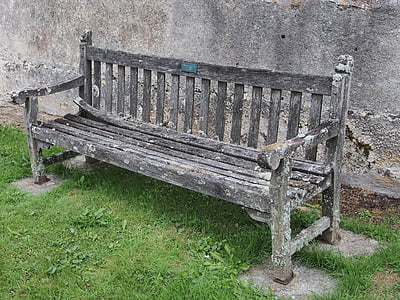 gray wooden bench beside wall thumbnail
