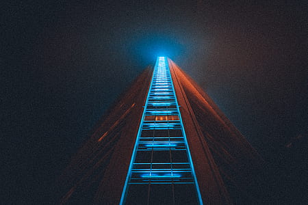 worm's eye view of high-rise building with blue LED lights thumbnail