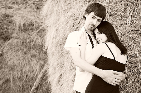 photo of couple hugging beside haystack thumbnail