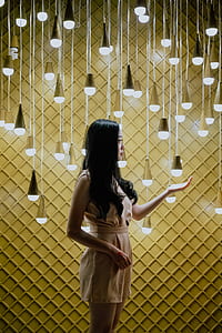woman standing near of white pendant bulbs thumbnail