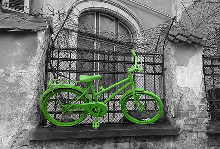 green commuter bicycle stuck on fence thumbnail