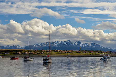 boat over water under white clouds at daytime thumbnail