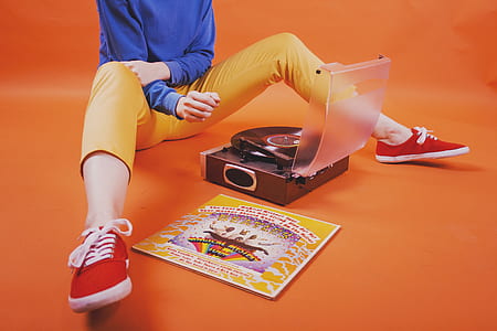 person sitting in front of black turntable thumbnail
