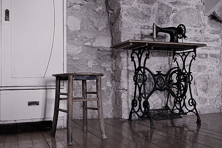 brown wooden stool beside black treadle sewing machine thumbnail
