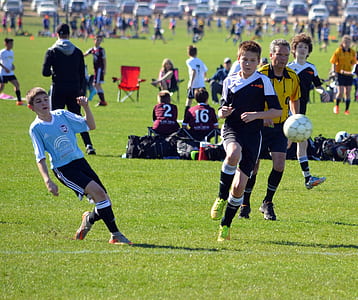 boys playing soccer at field thumbnail