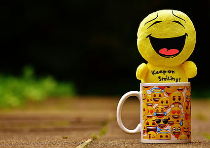 smiling emoji plush toy on emoji print mug thumbnail