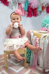 girl wearing pink and white tutu dress having a tea motif photo shoot thumbnail