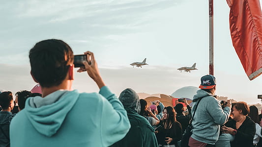 man taking photo of two fighter planes thumbnail