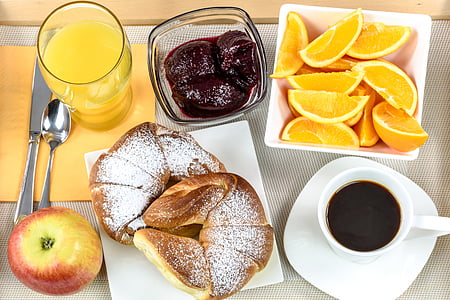 two croissants on square white ceramic plate beside red apple thumbnail