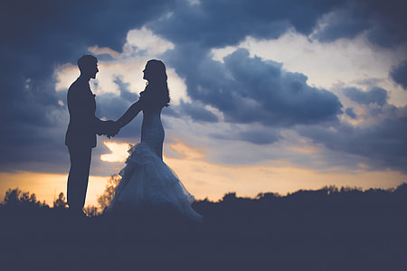 silhouette of man and woman standing during sunset thumbnail