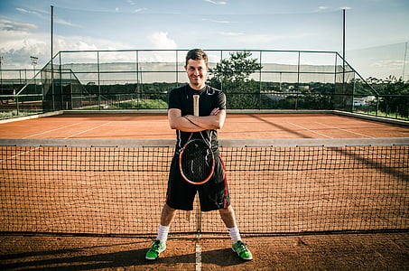 man holding tennis racket thumbnail