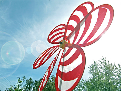 red and white striped nylon flower windmill at daytime thumbnail