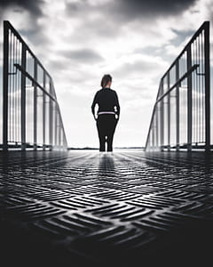 woman in black pants and sweatshirt standing at the end of stairs thumbnail
