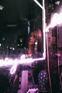 woman leaning on black wall thumbnail