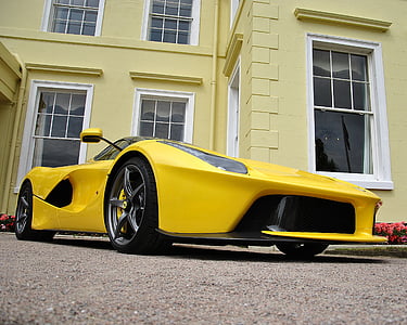 yellow Ferrari 458 parked near yellow concrete building thumbnail