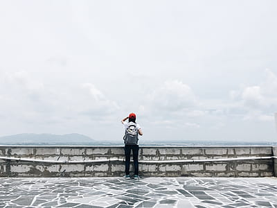 Man Standing Near Grey Wall thumbnail