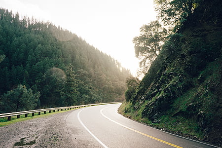 concrete road between mountains thumbnail