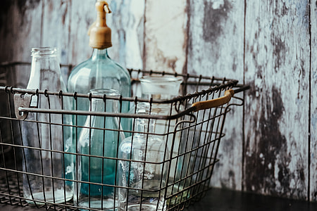 Collection of bottles in metal mesh basket thumbnail