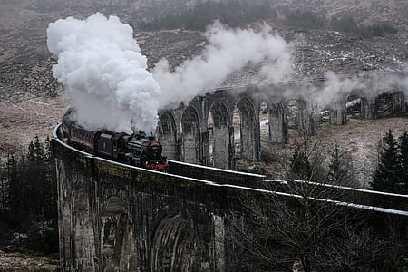 train traveling over river at daytime thumbnail