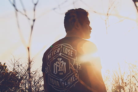 person standing near trees during daytime thumbnail