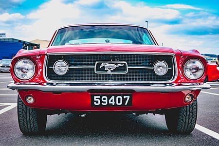red Ford Mustang parked on parking lot thumbnail