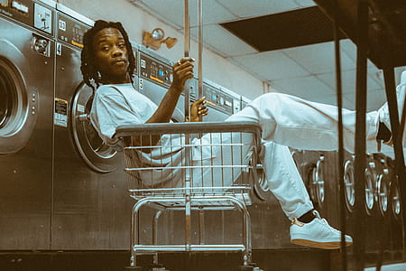 man sitting on cart in laundry shop thumbnail