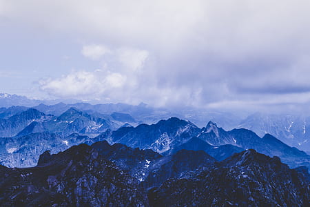 aerial view photography of mountain under cloudy sky thumbnail