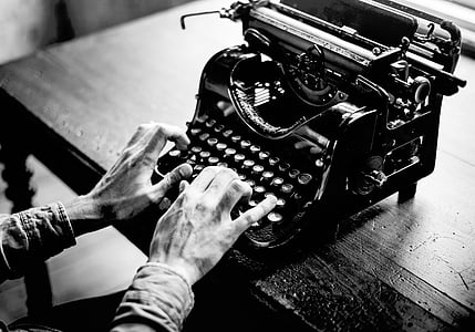 grayscale photo of person using typewriter thumbnail