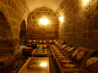 empty chairs beside coffee tables and brick wall thumbnail