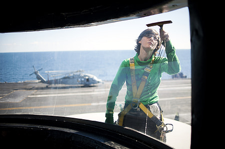 woman cleaning vehicle window thumbnail
