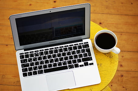 MacBook Air beside cup of coffee thumbnail