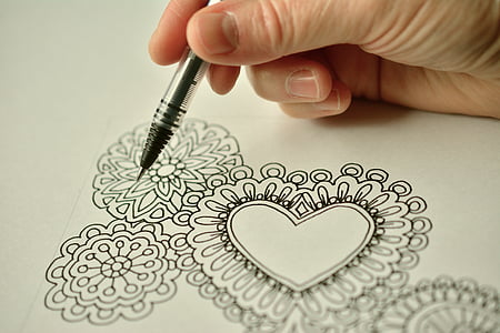 person holding pen drawing flowers thumbnail