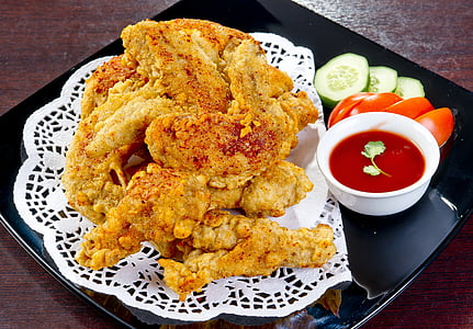 fried chickens with red sauce dip on black plate thumbnail