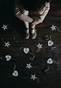 toddler sitting on floor looking at stars and hearts ornaments thumbnail