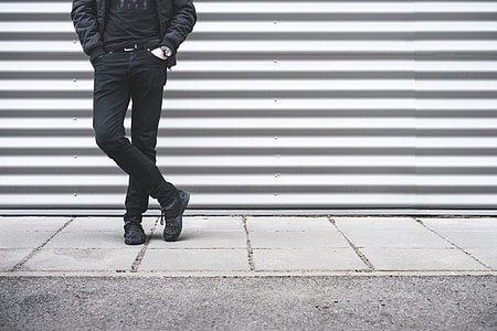 Man Standing in Front of Metallic Wall thumbnail