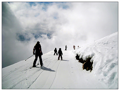 people doing snow ski under white clouds during daytime thumbnail
