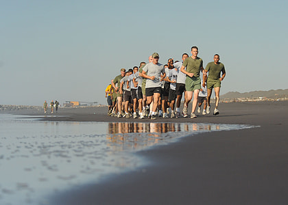 group of men running along the beach thumbnail