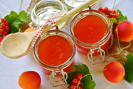 two clear glass jars beside brown wooden spatula thumbnail