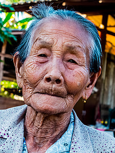 close photo of woman closing her mouth wearing gray collared top thumbnail