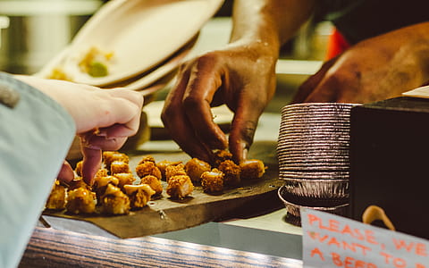 person holding meat dish thumbnail